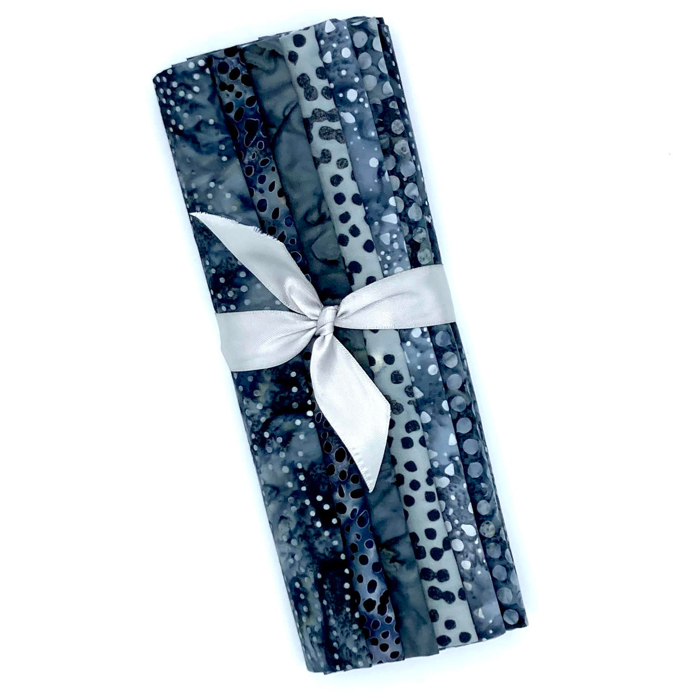 Six different grey toned batik fabric fat quarters in a bundle tied with a grey ribbon.