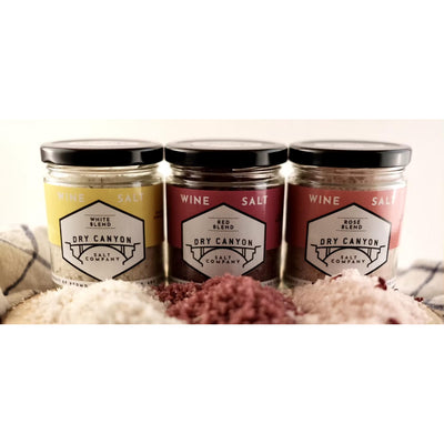 Three jars of Dry Canyon Salt Company salt on a textured surface with a white background