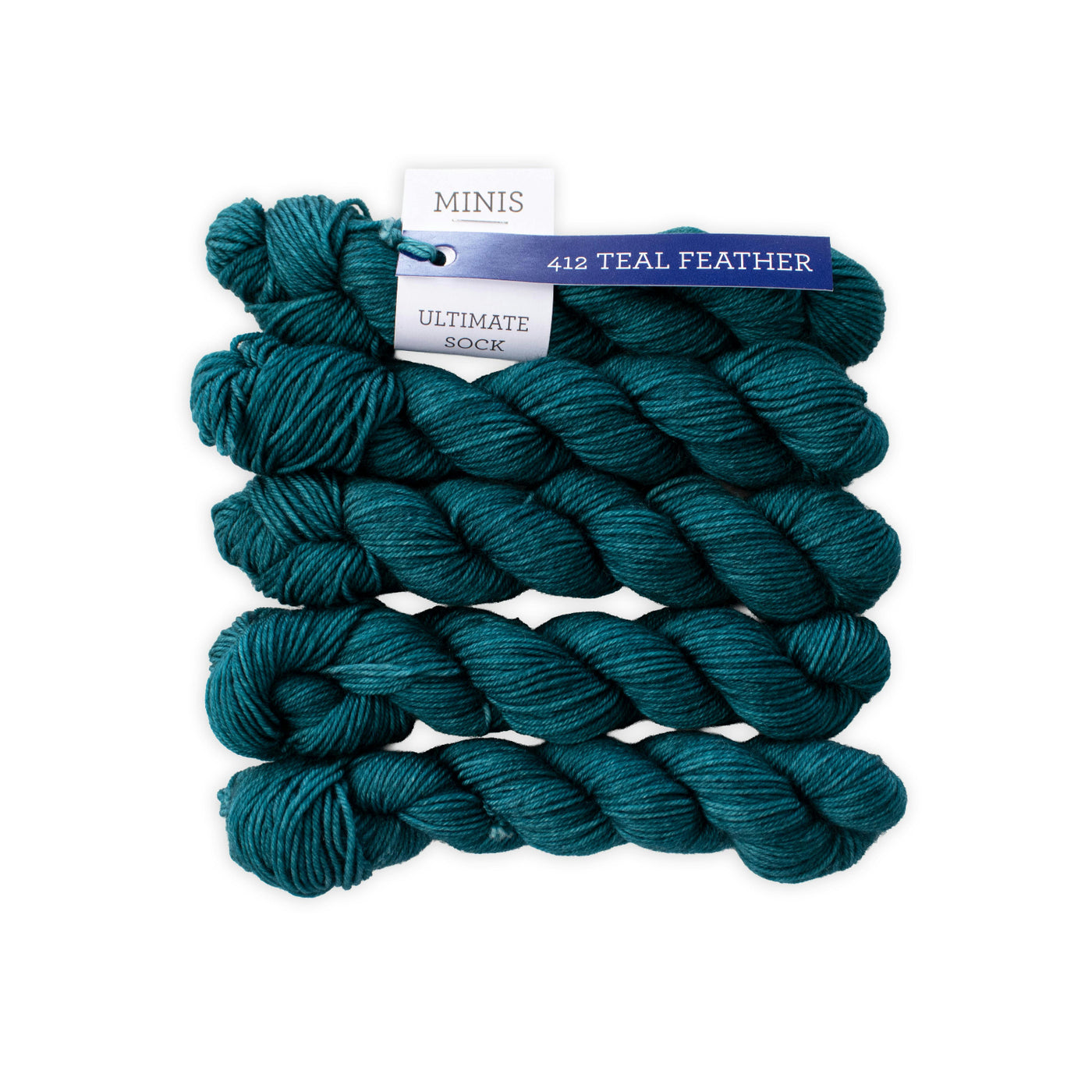 teal colored yarn skeins stacked on top of each other. 
