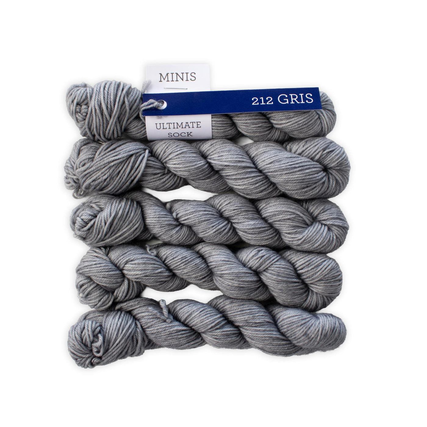 Grey yarn stacked on top of each other on a white background. 