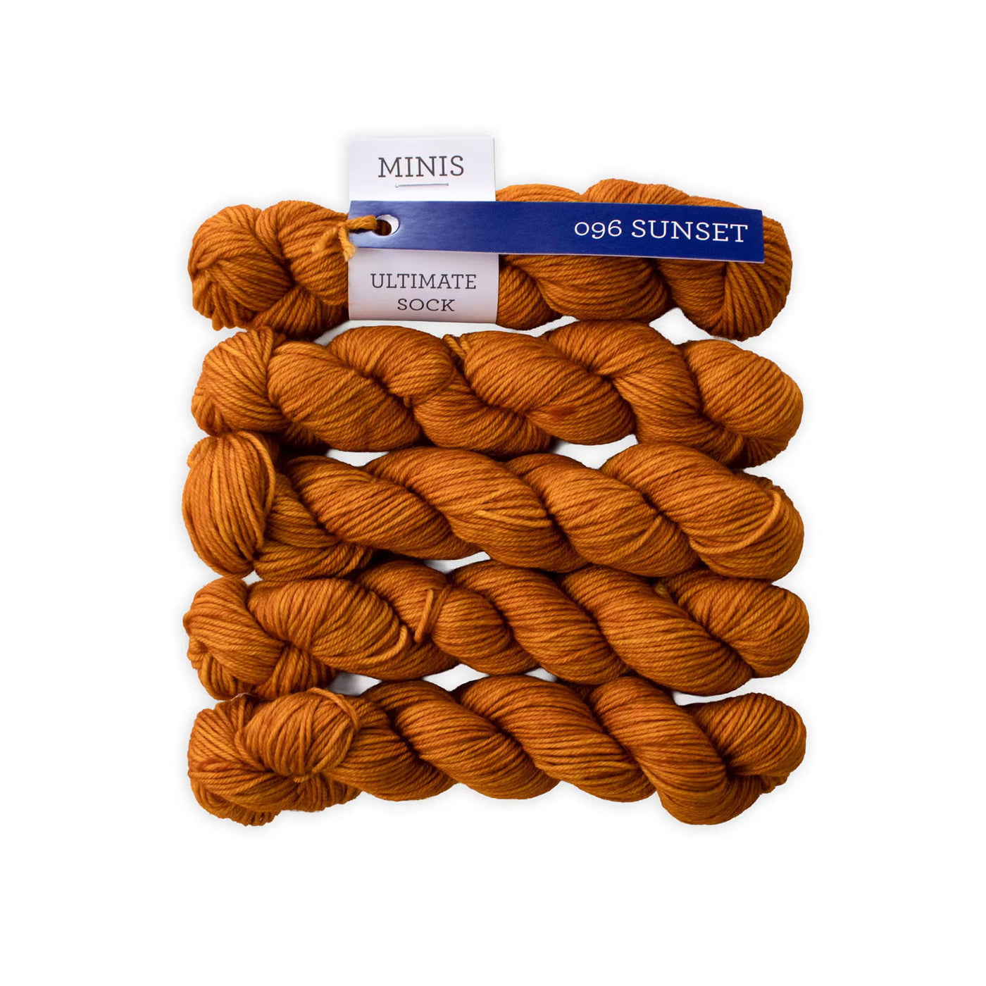 Orange yarn stacked together on a white background.